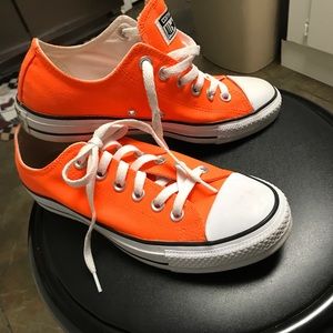 Bright orange Converse T- shoes.